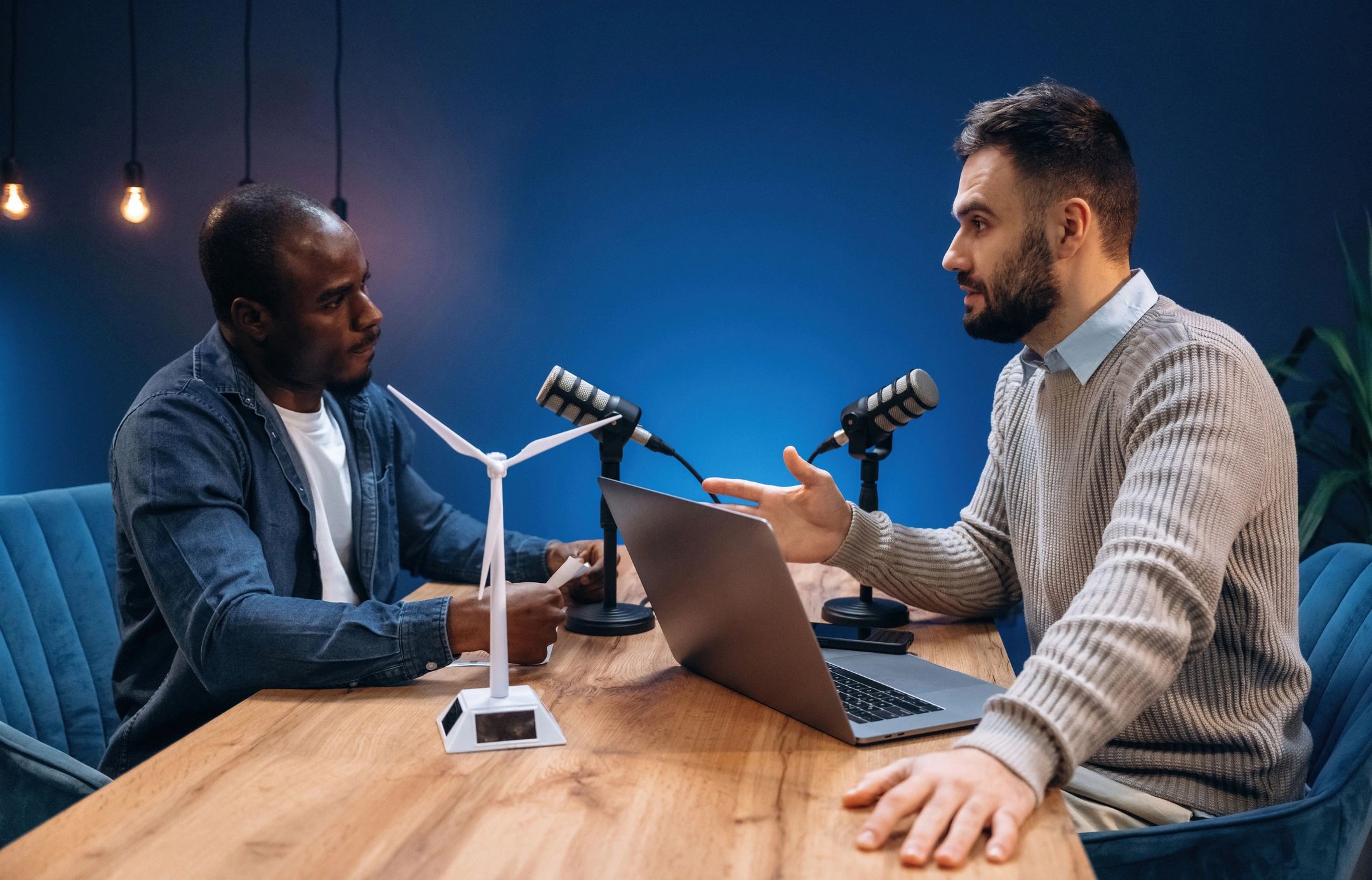 Two radio presenters recording an episode.